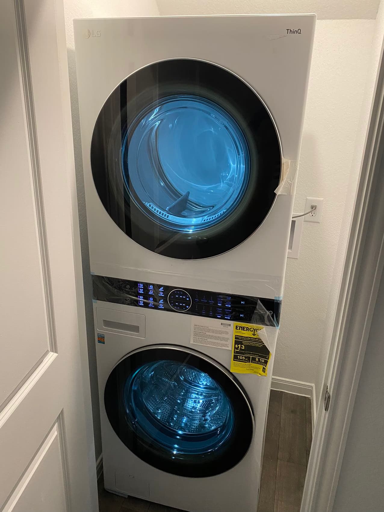 White LG WashTower installed in a narrow laundry alcove